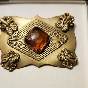 Ornate Brass-Tone Brooch with Amber Glass Stone